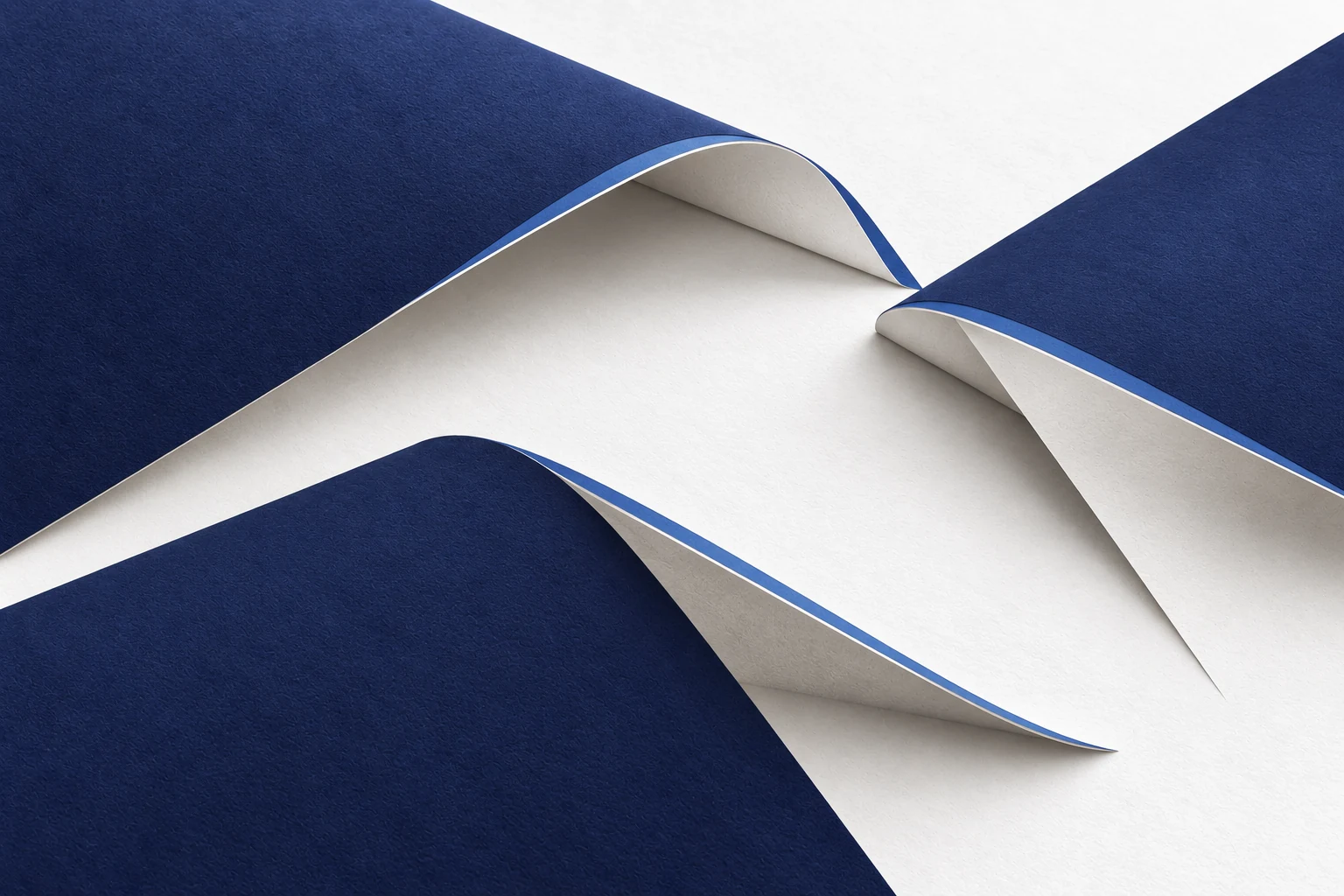 Three broad paper surfaces meet around an open space, each with its own support.